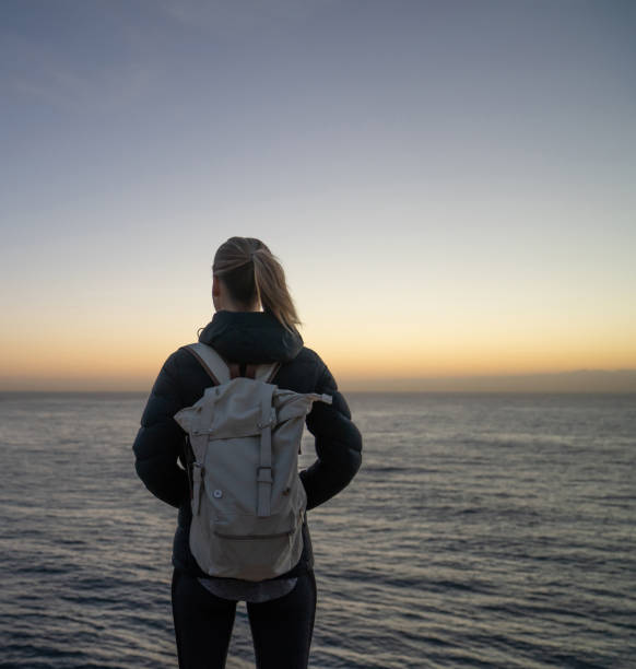 istock Hiker looking at the sunrise on a cliff 966705790