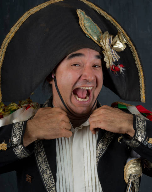 istock Laughing Commedia dell Arte performer in il Capitano costume adjusts his collar. 966715452