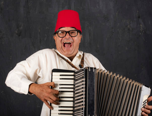 istock Commedia dell Arte performer with accordion performs with much energy. 966718746
