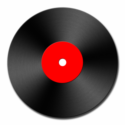 Two 7-inch single vinyl records with white labels on black slate background. Top view