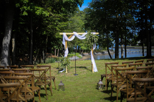 istock Wooden Wedding Altar Draped in White Fabric with Greenery Garland Decorations 966732946