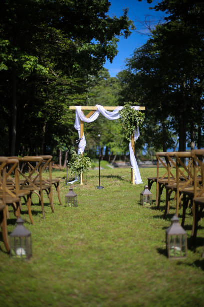 istock Wooden Wedding Altar Draped in White Fabric with Greenery Garland Decorations 966733032