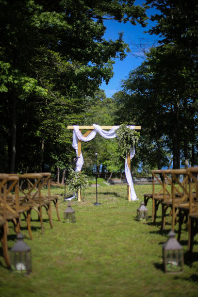 istock Wooden Wedding Altar Draped in White Fabric with Greenery Garland Decorations 966733034