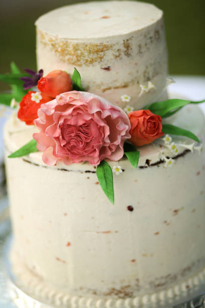 istock White Naked Layered Wedding Cake with Pink Peony and Roses on a Silver Platter 966735512