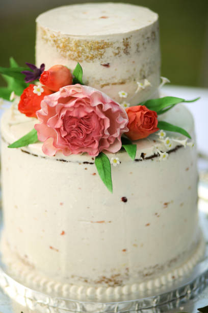 istock White Naked Layered Wedding Cake with Pink Peony and Roses on a Silver Platter 966735542