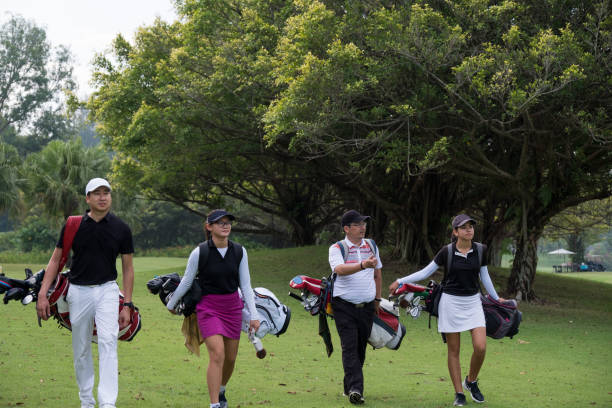 istock Friends walk together down the fairway 966735570