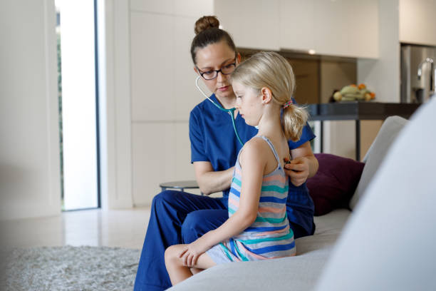 istock Home Call Nurse Examining Child At Home 966738636
