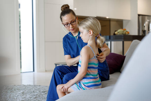 istock Home Call Nurse Examining Child At Home 966738640