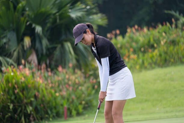Woman golfer takes a long putt