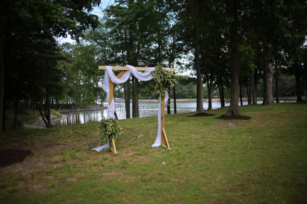 istock Wooden Wedding Altar Draped in White Fabric with Greenery Garland Decorations 966739198