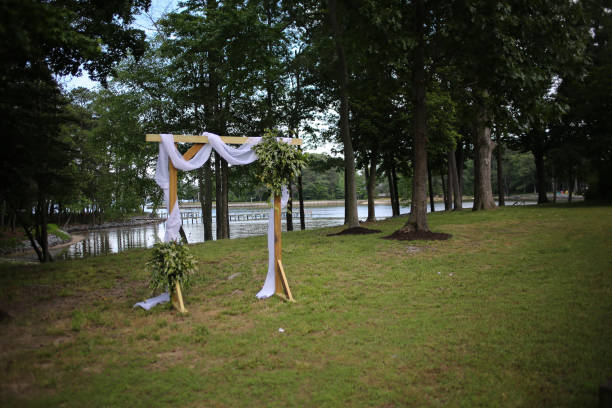 istock Wooden Wedding Altar Draped in White Fabric with Greenery Garland Decorations 966739718