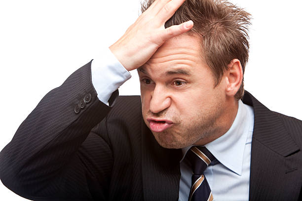 Businessman with forgetful face and hand on head stock photo