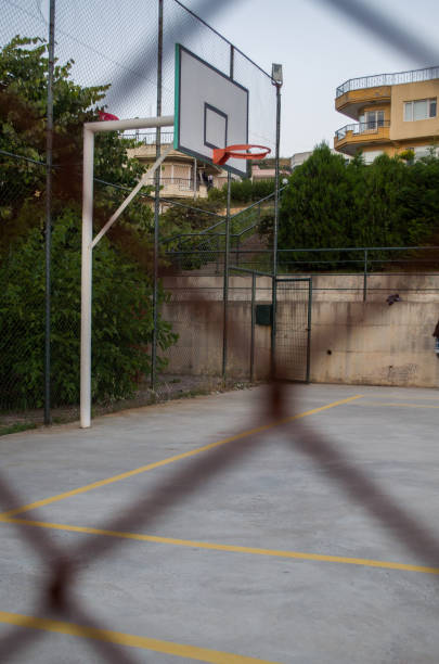 istock Basketball court behind a rusty fence 966749890