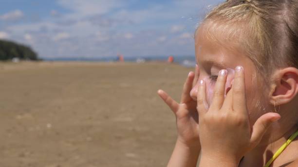 istock Apply sunscreen to face and body. 966754168