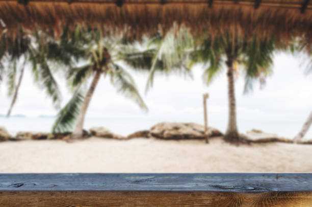 istock Beach Background, wooden table top and blurred defocus tropical beach background 966757778