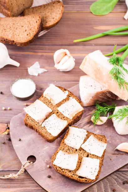 istock Sandwiches from rye bread and salted bacon on a cutting board 966758252