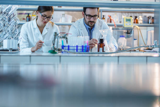 istock Young biochemists working on new experiment in laboratory. 966766052