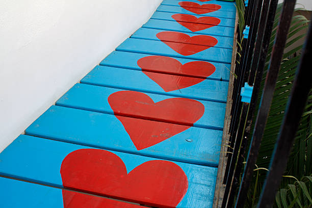 hand painted red hearts on blue walkway from mid Mexico for Valentine's day. This walkway is to a wedding room on the second floor of a house.