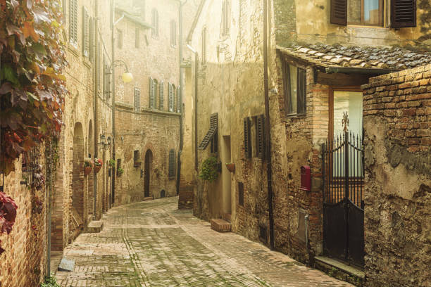 Street in an old italian town in Tuscany Medieval hilltop town in Italy medieval architecture stock pictures, royalty-free photos & images
