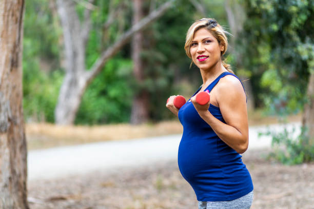 istock Pregnant Hispanic Woman Working Out 966769932