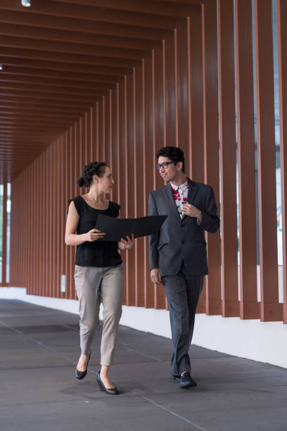 istock Two colleagues talking on their way to a meeting 966777804