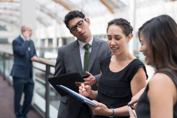 istock Three business colleagues go over notes before their conference presentation 966777808