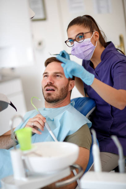 istock Dentist talk with patient about his teeth 966778834