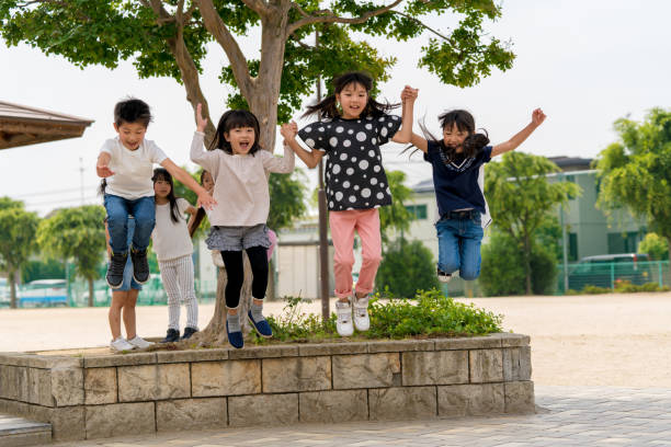 istock Group of young school friends playing together 966781248