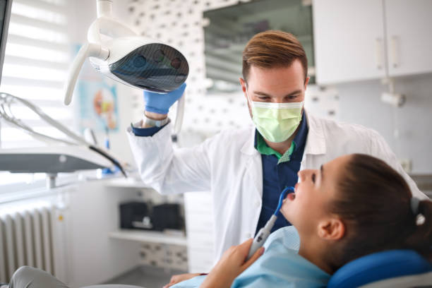 istock Dentist examining girl on clinic 966781894