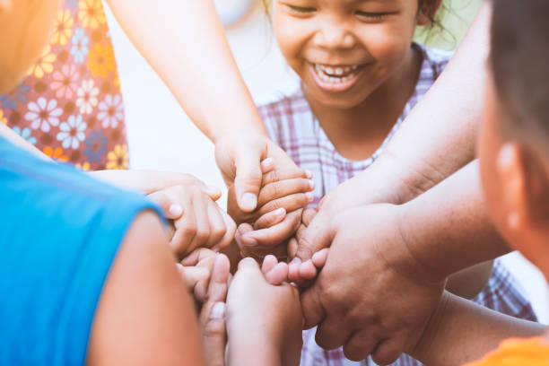 istock Children and parent holding hands and playing together with unity and teamwork 966783098