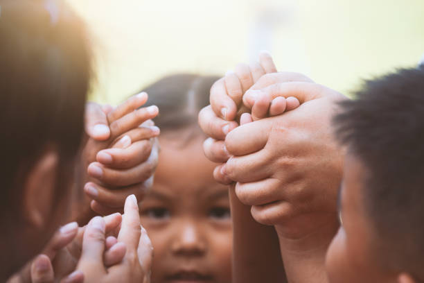 istock Children and parent holding hands and playing together with unity and teamwork 966783116