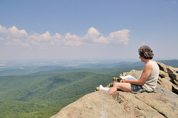 istock Hiker Studying the Bible atop a Mountain 96678511