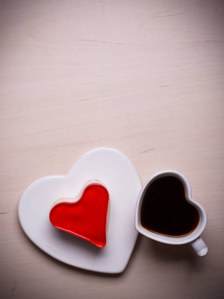 istock Heart shaped coffee cup and cake on wood surface 966790202