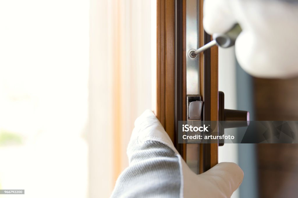 Construction worker installing window in house. Handyman fixing the window with screwdriver Window Stock Photo