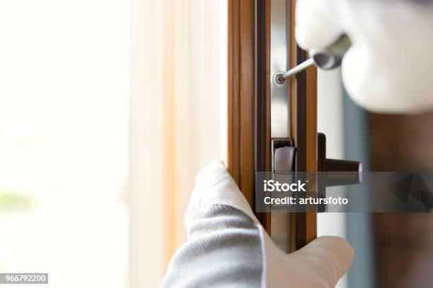 Construction Worker Installing Window In House Handyman Fixing The Window With Screwdriver Stock Photo - Download Image Now