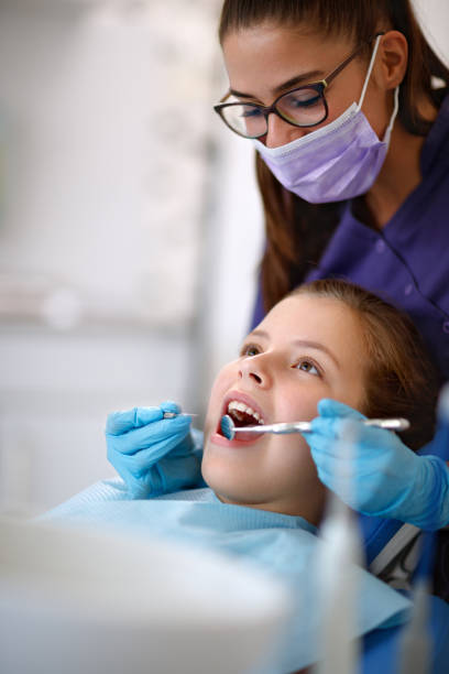 Dentist at work with patient in ambulant Dentist at work with young female patient in ambulant ambulant patient stock pictures, royalty-free photos & images