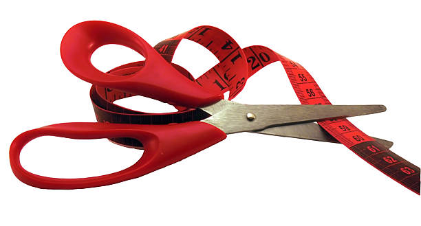 istock The scissors cutting a measuring tape. 96679714