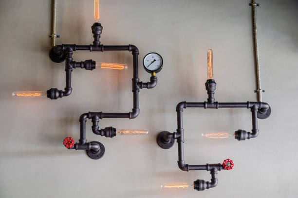 istock steel pipe and lamp on wall 966802612