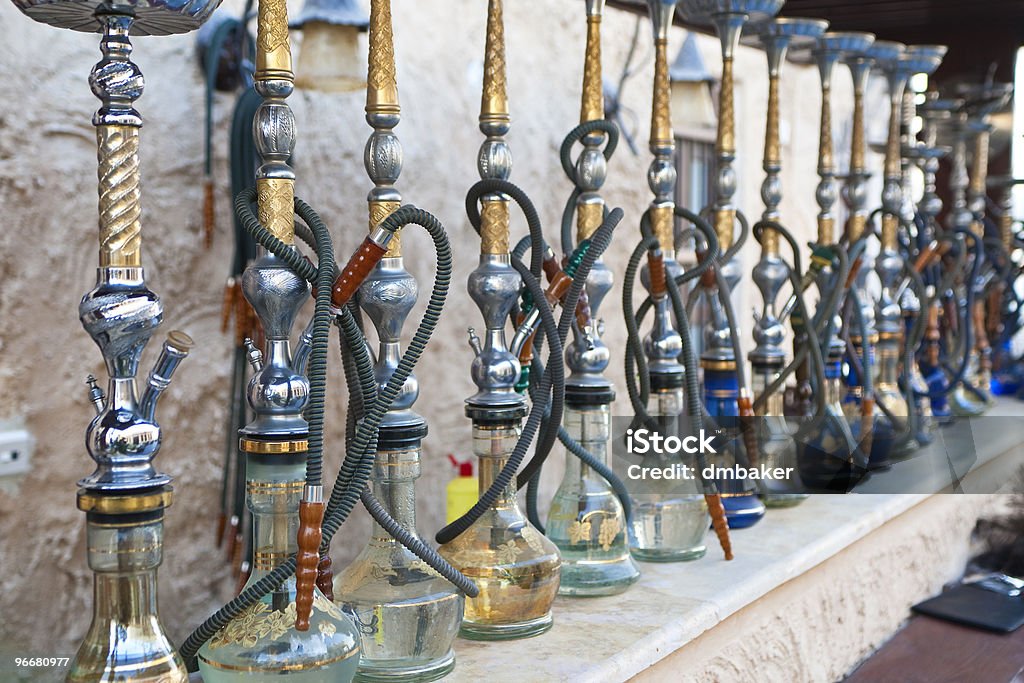 Arabic Shisha Waterpipes Lined Up In A Restaurant Arabic shisha, sometimes called hookah, waterpipes lined up on a bar for customers in a restaurant in an Arabic country. Hookah Stock Photo