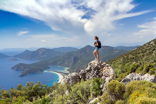 Hiker girl on the mountain top. Sport and active life concept. Oludeniz, Turkey