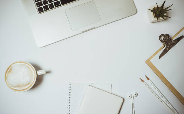 istock Work space with laptop, coffee and stationery on white table. Top view, Flat lay 966813814
