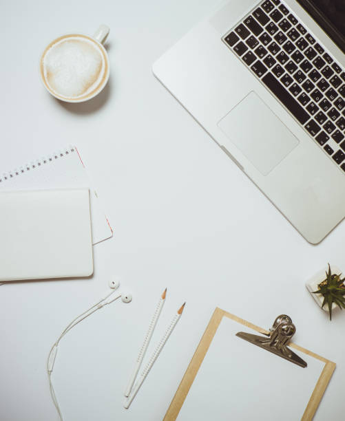 istock Creative desktop with laptop, coffee and stationery on white table. Top view, Flat lay 966814088