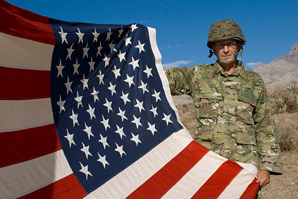 istock Soldier holding the U.S. Flag 96681694