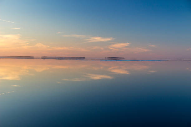 istock Sea surface with reflection of sky and clouds at sunset 966817388