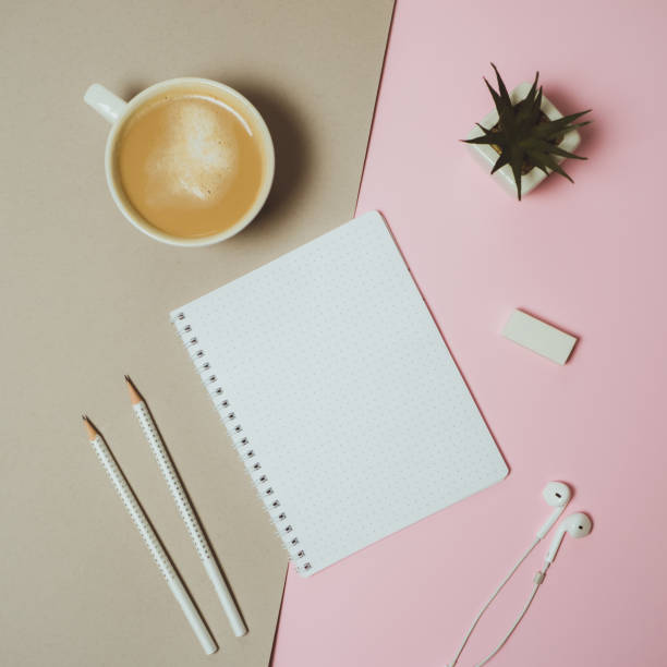 istock Minimal home desk workspace with clipboard, pen, coffee mug on pastel pink and grey  background. Flat lay, top view 966818868