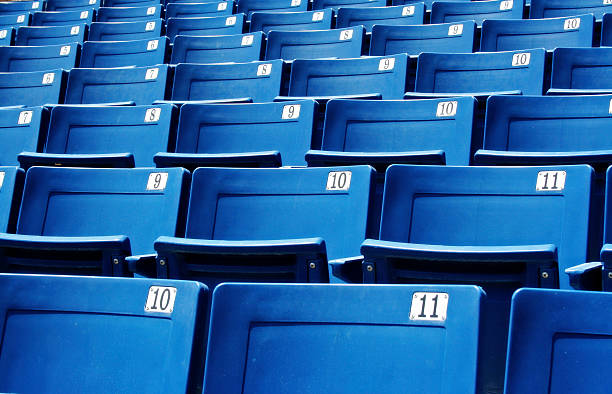 Close-up of numbered blue stadium seats