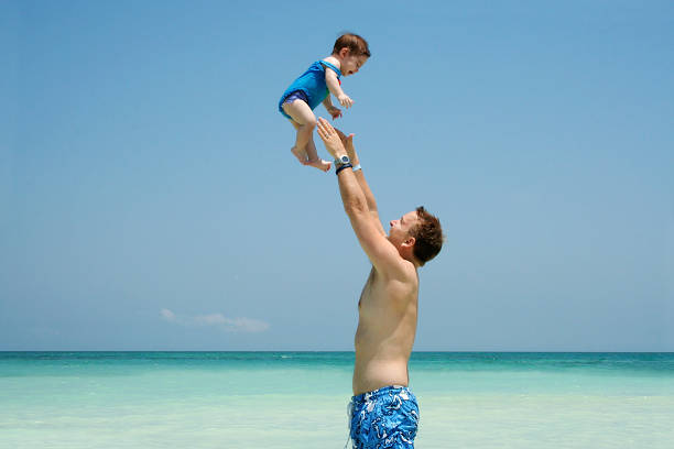 istock Father and daughter playing at the beach 96682120