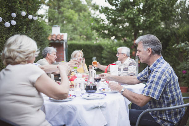 istock Senior people, friends, enjoying backyard barbecue 966828042