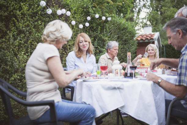 istock Senior people, friends, enjoying backyard barbecue 966828138