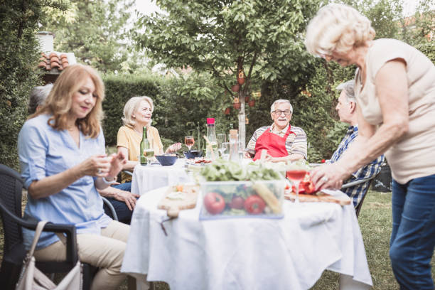 istock Senior people, friends, enjoying backyard barbecue 966828284